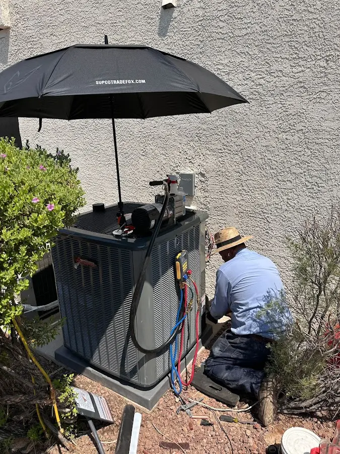 HVAC technician performing outdoor AC maintenance in Westtown